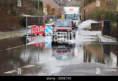 Vehicles driving through flood water on a road in Pimperne in Dorset in Jan 2026 after Storm Chandra and very heavy rainfall causes severe flooding Stock Photo