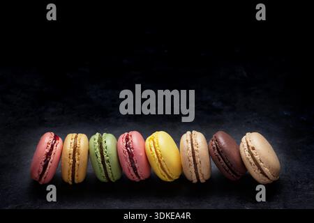 Colorful macaroons on stone table. Sweet macarons. View with copy space for your text Stock Photo
