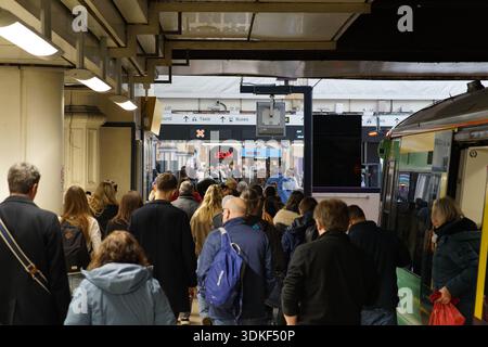 Crowded platform at London Victoria station during busy rush hour with commuters boarding train. Victoria station , London,England Stock Photo