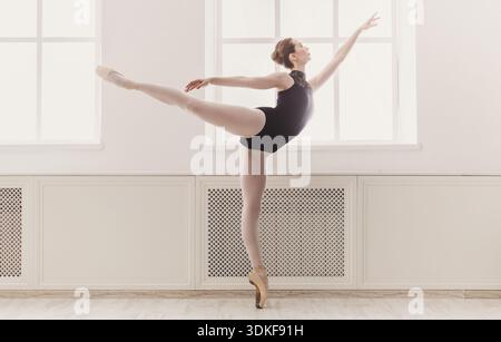 Beautiful woman ballerina in arabesque ballet position Stock Photo