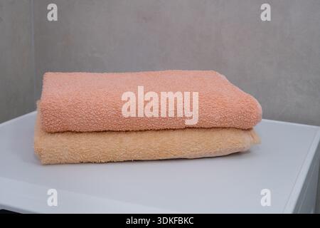 Neatly Folded Soft Terry Cloth Towels in Pastel Colors, Perfect for a Spa or Bathroom Setting Stock Photo