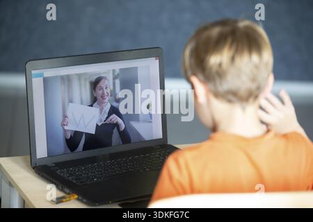The remote teacher speaks via video link with the student. Online education and e-learning concept. Home quarantine, distance learning and work from h Stock Photo