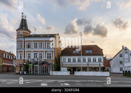 Sunset and colourful clouds over some houses in the harbour of Svenborg, Denmark, July 10, 2019 Stock Photo