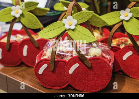 Baskets similar to cherries are made of cloth on the table Stock Photo