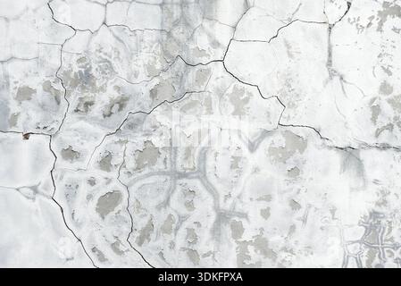 Background of gray crannied wall covered with rough flaking plaster Stock Photo