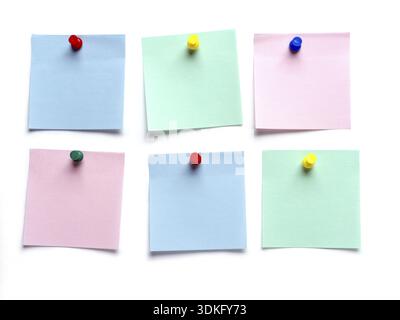 Six blank post-it notes pinned on white surface Stock Photo