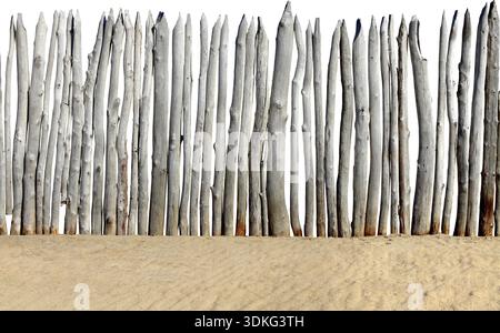 Old wooden fence on the sand isolated on the white background Stock Photo