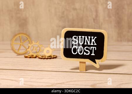 Sunk Cost is shown using a text. Stock Photo