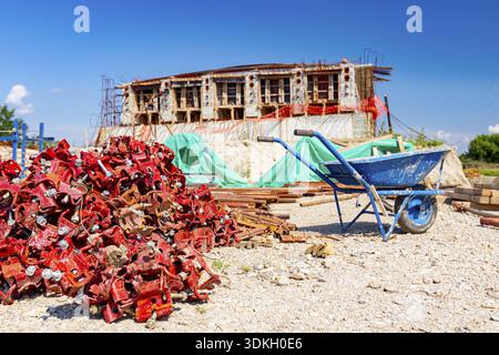 View on heap of disassembled steel scaffolding joint on construction site Stock Photo