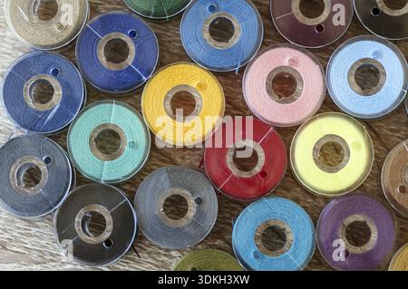 Close-up on colored sewing threads on spools. Top view Stock Photo