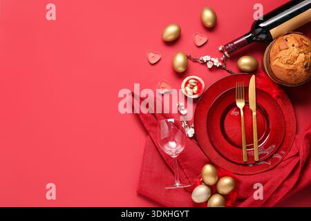 Beautiful table setting with Easter eggs on red background Stock Photo