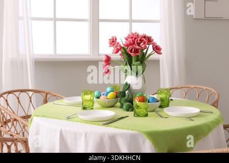 Beautiful table serving for Easter celebration in light dining room Stock Photo