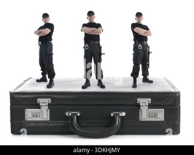 Three security guys standing on black cipher suitcase shot on white, security concept Stock Photo