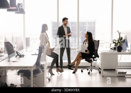 Group of professional staff members discussing joint project in office Stock Photo