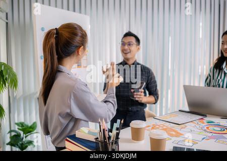 UX/UI designers collaborating during a creative workshop to test interface ideas and exchange feedback for app development, emphasizing teamwork and i Stock Photo