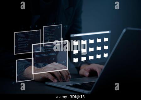 Hacker typing on laptop with digital file folders and coding interface, concept of cyber attack, data theft, information security breach, and online p Stock Photo