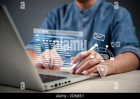 professional using a stylus on a laptop to interact with a virtual AI-powered interface that displays emails and a chatbot, showcasing the role of AI Stock Photo