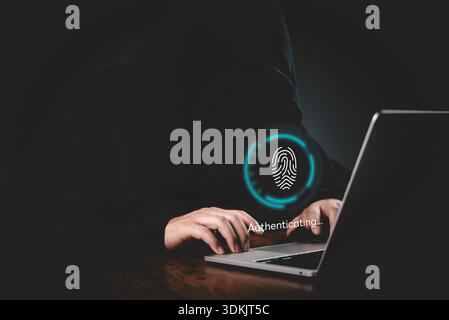 Authentication, Security Hands on a keyboard with a glowing fingerprint UI authenticating on a laptop to demonstrate protected access, data protection Stock Photo