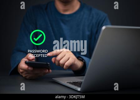 Security, Password Hands holding smartphone show password accepted next to laptop in home office to complete login, illustrating strong 2FA, OTP, and Stock Photo