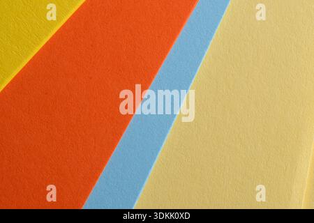 Colorful sheets of paper lay side by side, inviting creativity and artistic designs. Stock Photo