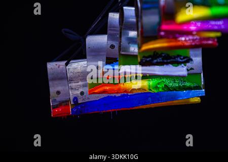 Smooth Transition of Rainbow Hues on Fabric Print Handles.    From red to violet, the colors merge gracefully on wooden handles, symbolizing creativit Stock Photo