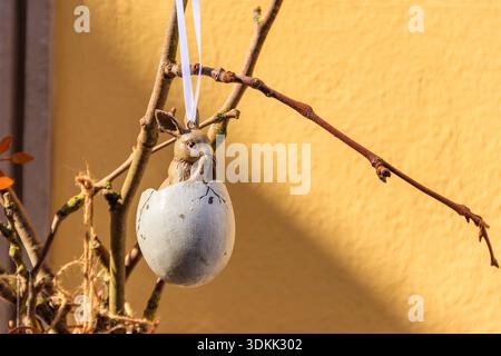 Easter egg with Easter bunny hanging on a twig. Easter decoration Stock Photo