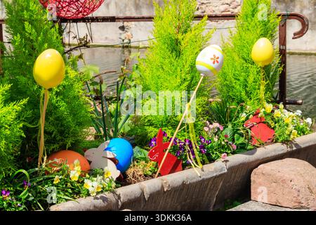 Flowerbed with flowers and Easter decoration at spring Stock Photo