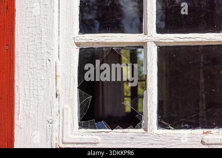 Broken glass window on a cottage Stock Photo