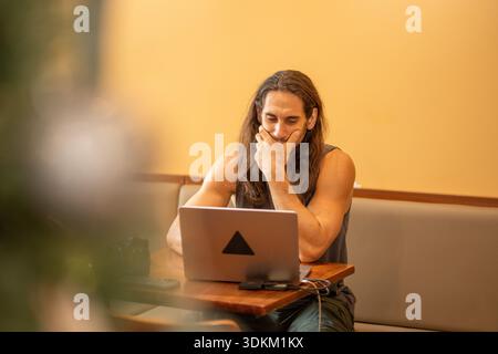 Man working on laptop thinking about a problem solution Stock Photo