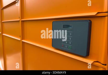 Close up view of a parcel locker keypad on a metal delivery locker,  modern logistics and security concept. Stock Photo