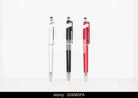 Three ballpoint pens in different colors arranged on a clean white background. Great for stationery collections, office supplies, school items, writin Stock Photo