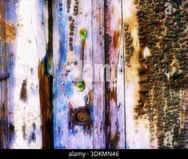 A close-up view of a weathered door showing rich texture and decay. Stock Photo