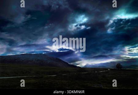 Storm clouds gather as day breaks over the northern fells of the English Lake District. Stock Photo