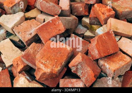 Pile of broken red clay bricks and construction debris, closeup Stock Photo
