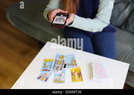 Tarot cards spread analyzed by artificial intelligence using smartphone Stock Photo