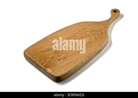 Wooden cutting board with a curly handle isolated on white background. Stock Photo