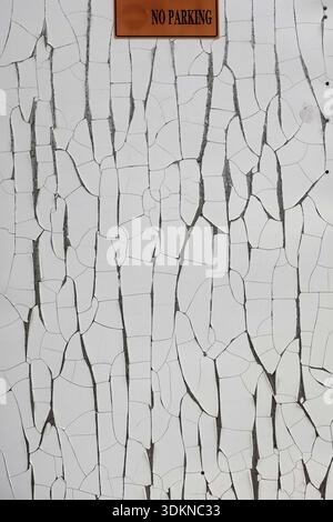 No parking sign on blank split plastic surface. Abstract weathered grunge background texture. Stock Photo