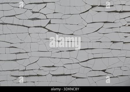 Abstract shapes background cracked split plastic film weathered grunge texture. Stock Photo