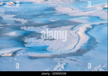 Stunning high angle perspective of frozen Baltic Sea showing intricate ice formations creating natural abstract patterns Stock Photo