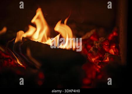 Burning wood, log, embers, fire in a fireplace Stock Photo