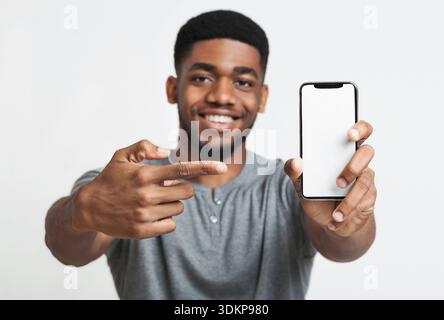 Happy black man holding latest slim smartphone Stock Photo