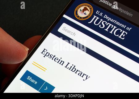 Epstein Library on U.S. Department of Justice justice.gov displayed on smartphone screen with DOJ seal, search field and share button in close-up. Sta Stock Photo