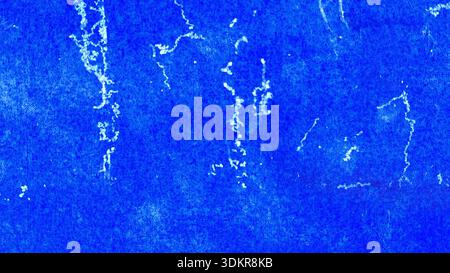 Distressed Royal Blue Construction Paper Surface with White Paint Splatter and Grungy Artistic Weathered Texture Stock Photo
