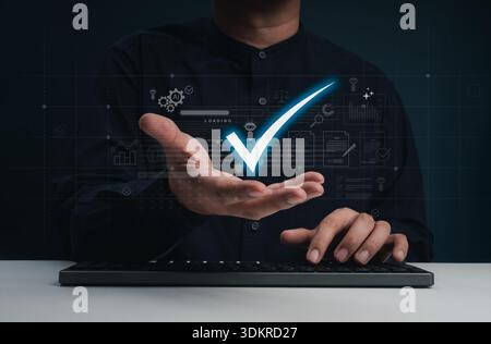 Businessman uses AI workflow automation to increase productivity with smart check mark symbol in hand while work with computer. Successful digital pro Stock Photo