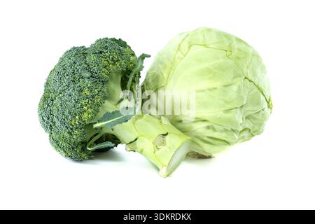 whole head of green cabbage and a fresh broccoli floret are presented together against a stark white backdrop, highlighting their natural textures a Stock Photo