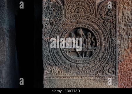 Ajanta, India - 26 December 2025: View of the dark, textured carvings in the Ajanta caves, where intricate details and ancient artistry emerge from th Stock Photo