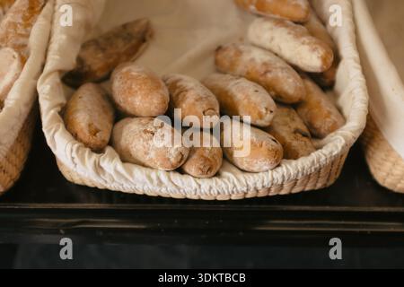 Freshly baked rolls in artisanal wicker bread basket Stock Photo