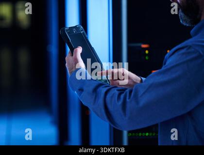 Close-up of man using tablet in data center Stock Photo