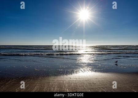 USA, Oregon, Sun setting over ocean and empty Cannon Beach Stock Photo