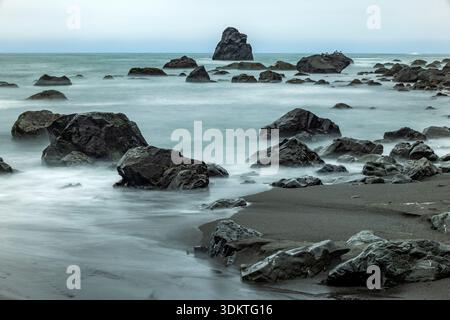 USA, Oregon, Brookings, Sea waves on rocky coast, long exposure Stock Photo